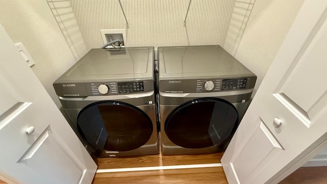 6159 Peaceful Park Way, Clermont, FL 34714 - washroom featuring separate washer and dryer and wood finished floors