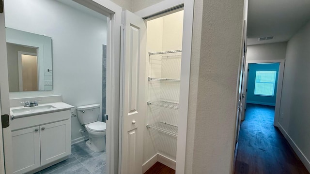 6159 Peaceful Park Way, Clermont, FL 34714 - bathroom featuring toilet, vanity, and baseboards