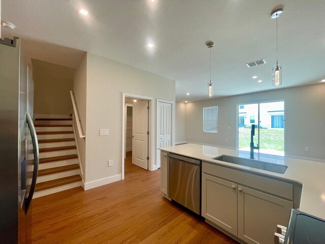 6159 Peaceful Park Way, Clermont, FL 34714 - kitchen with stainless steel appliances, light wood-type flooring, light countertops, pendant lighting, and recessed lighting