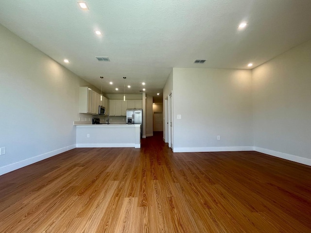 6159 Peaceful Park Way, Clermont, FL 34714 - unfurnished living room with baseboards, wood finished floors, and recessed lighting