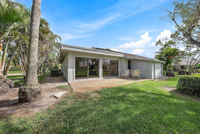 6170 Brandon St, Palm Beach Gardens, FL 33418 - back of house featuring a patio area, a yard, and stucco siding