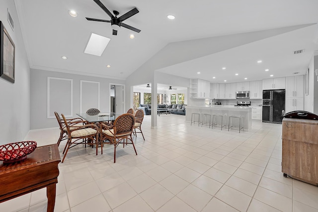 6170 Brandon St, Palm Beach Gardens, FL 33418 - dining room with ceiling fan, vaulted ceiling, recessed lighting, light tile patterned floors, and a skylight