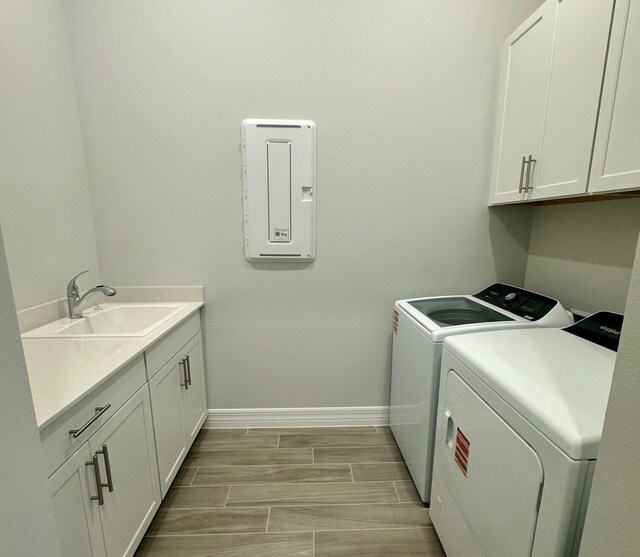 10710 Stellar Cir Unit 03, Palm Beach Gardens, FL 33412 - laundry area featuring separate washer and dryer, cabinet space, and baseboards