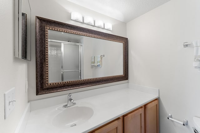 6057 Ridgelake Cir, Vero Beach, FL 32967 - full bathroom featuring toilet, vanity, a shower stall, and a textured ceiling