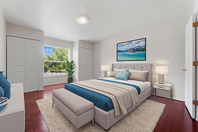 6057 Ridgelake Cir, Vero Beach, FL 32967 - bedroom with two closets, dark wood finished floors, and baseboards