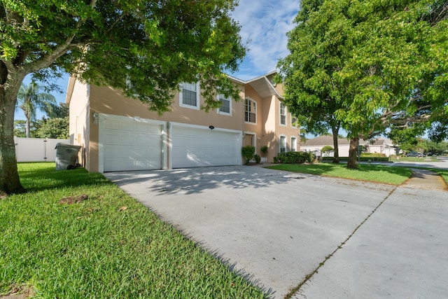 6057 Ridgelake Cir, Vero Beach, FL 32967 - view of front of house with stucco siding, a garage, and concrete driveway