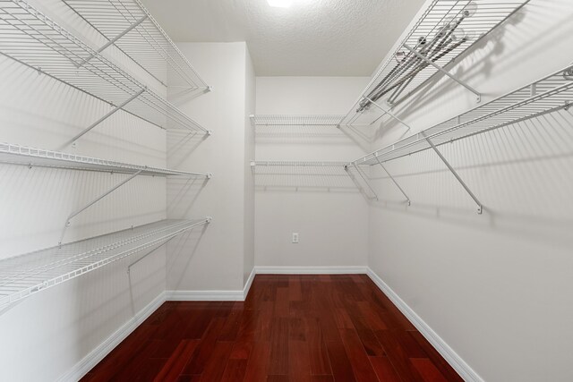 6057 Ridgelake Cir, Vero Beach, FL 32967 - walk in closet featuring wood finished floors