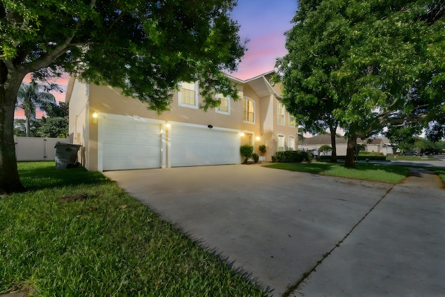 6057 Ridgelake Cir, Vero Beach, FL 32967 - view of front of house featuring stucco siding, driveway, and a garage