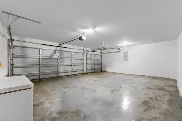 6057 Ridgelake Cir, Vero Beach, FL 32967 - garage featuring electric panel and a garage door opener