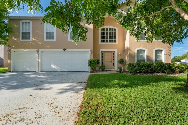 6057 Ridgelake Cir, Vero Beach, FL 32967 - view of front of home featuring stucco siding, an attached garage, concrete driveway, and a front yard