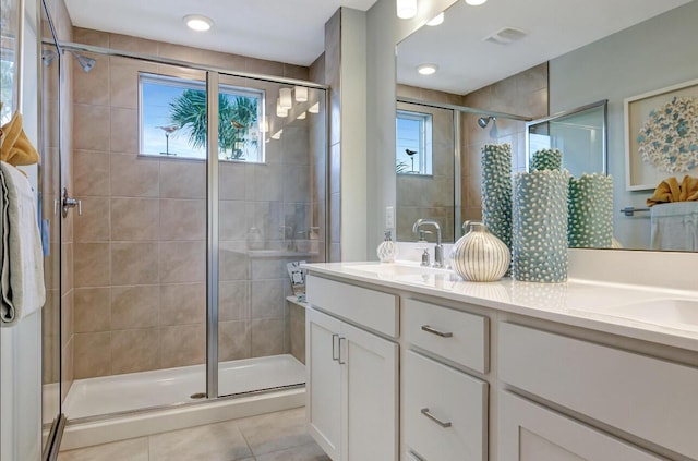 608 Waters Edge Ln Unit 2202, Port Saint Lucie, FL 34983 - full bath featuring plenty of natural light, tile patterned flooring, double vanity, and a stall shower