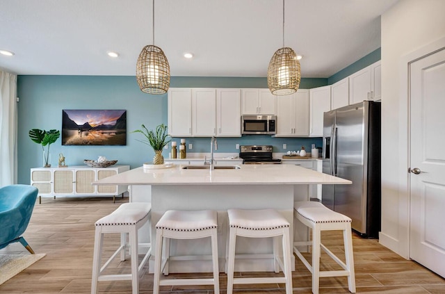 608 Waters Edge Ln Unit 2202, Port Saint Lucie, FL 34983 - kitchen featuring appliances with stainless steel finishes, a sink, light countertops, white cabinets, and recessed lighting