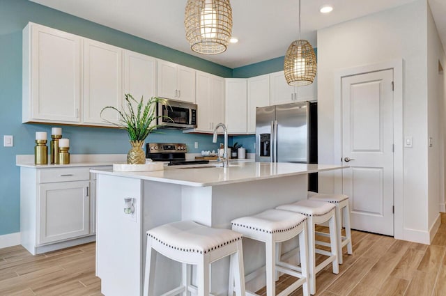 608 Waters Edge Ln Unit 2202, Port Saint Lucie, FL 34983 - kitchen featuring appliances with stainless steel finishes, baseboards, light wood-type flooring, light countertops, and recessed lighting