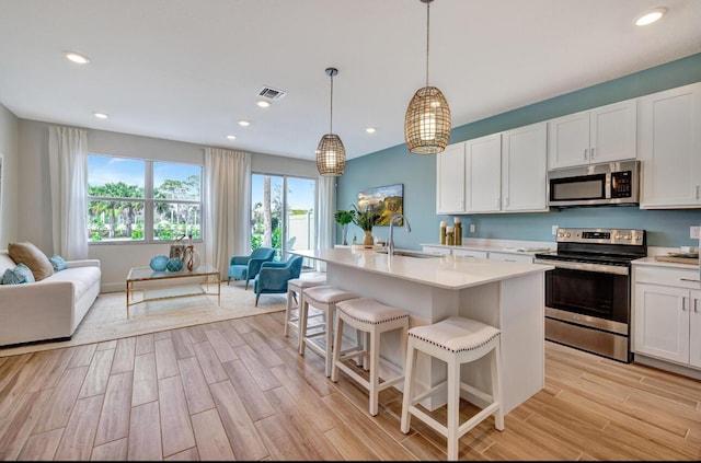 608 Waters Edge Ln Unit 2202, Port Saint Lucie, FL 34983 - kitchen featuring stainless steel appliances, open floor plan, a sink, healthy amount of natural light, and recessed lighting