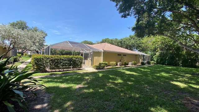 9124 Sun Terrace Cir Unit D, West Palm Beach, FL 33403 - rear view of property featuring a yard, a lanai, and stucco siding
