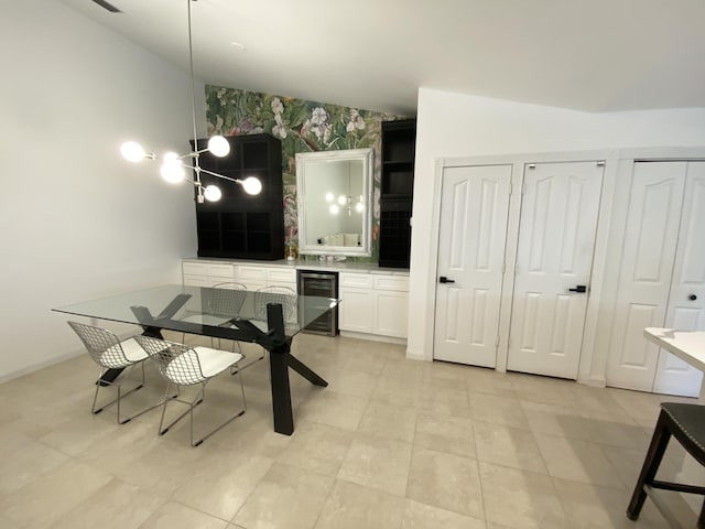 9124 Sun Terrace Cir Unit D, West Palm Beach, FL 33403 - dining room featuring beverage cooler, an accent wall, and baseboards