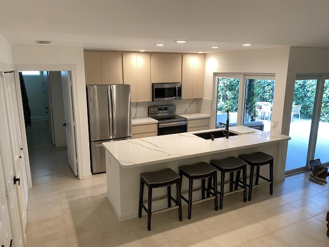 9124 Sun Terrace Cir Unit D, West Palm Beach, FL 33403 - kitchen featuring appliances with stainless steel finishes, a sink, a kitchen breakfast bar, healthy amount of natural light, and recessed lighting