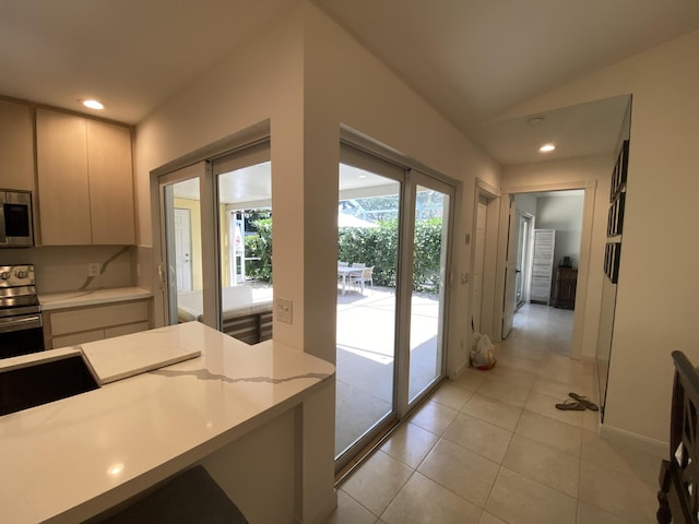 9124 Sun Terrace Cir Unit D, West Palm Beach, FL 33403 - kitchen featuring appliances with stainless steel finishes, light countertops, light tile patterned floors, recessed lighting, and lofted ceiling