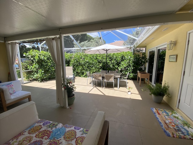 9124 Sun Terrace Cir Unit D, West Palm Beach, FL 33403 - view of patio / terrace featuring outdoor dining space and glass enclosure