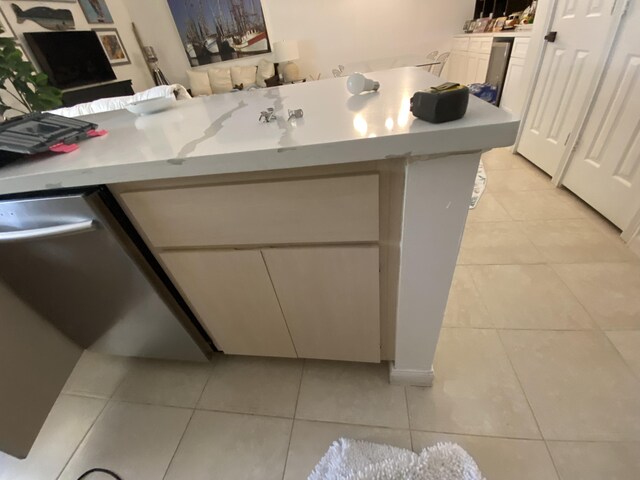 9124 Sun Terrace Cir Unit D, West Palm Beach, FL 33403 - kitchen featuring light tile patterned flooring, light countertops, and stainless steel dishwasher
