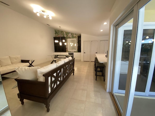 9124 Sun Terrace Cir Unit D, West Palm Beach, FL 33403 - living room with lofted ceiling, a chandelier, light tile patterned floors, and recessed lighting