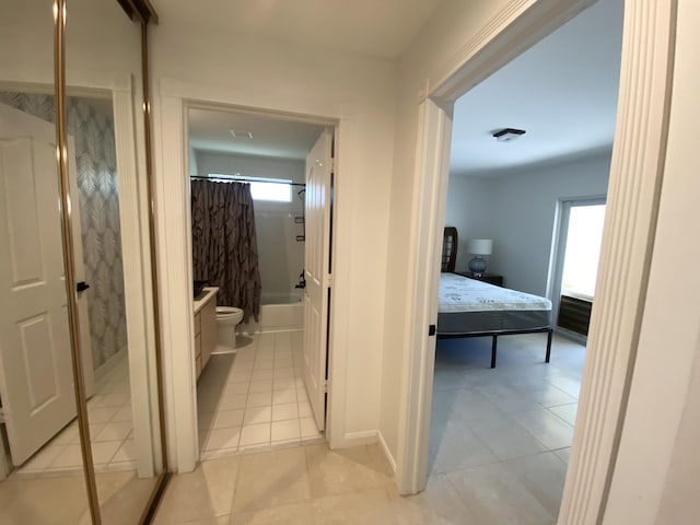 9124 Sun Terrace Cir Unit D, West Palm Beach, FL 33403 - corridor with light tile patterned floors, plenty of natural light, and baseboards