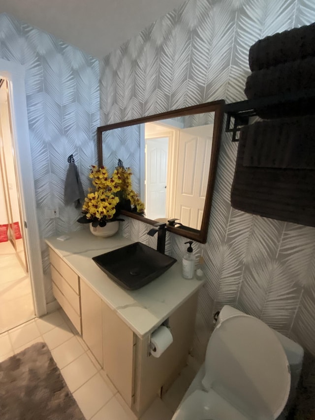 9124 Sun Terrace Cir Unit D, West Palm Beach, FL 33403 - bathroom with wallpapered walls, tile patterned flooring, and vanity