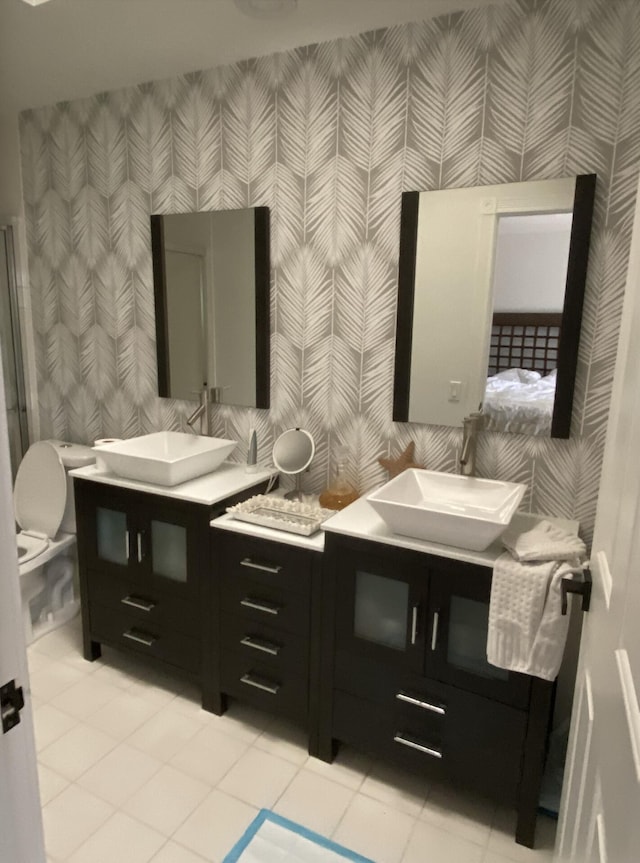 9124 Sun Terrace Cir Unit D, West Palm Beach, FL 33403 - bathroom with wallpapered walls, toilet, vanity, and tile patterned floors