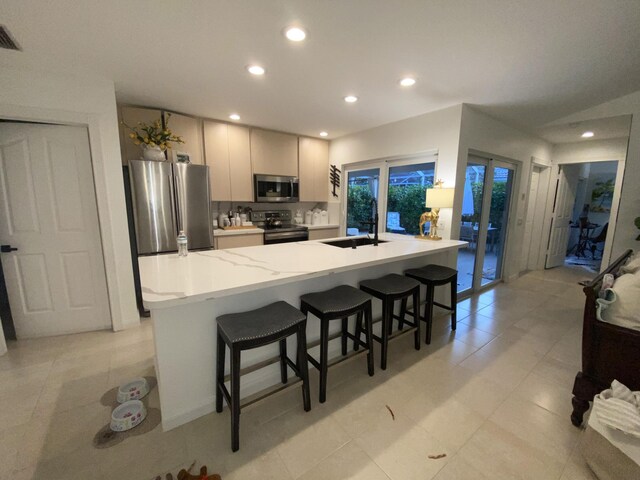 9124 Sun Terrace Cir Unit D, West Palm Beach, FL 33403 - kitchen featuring stainless steel appliances, french doors, a kitchen bar, recessed lighting, and a sink