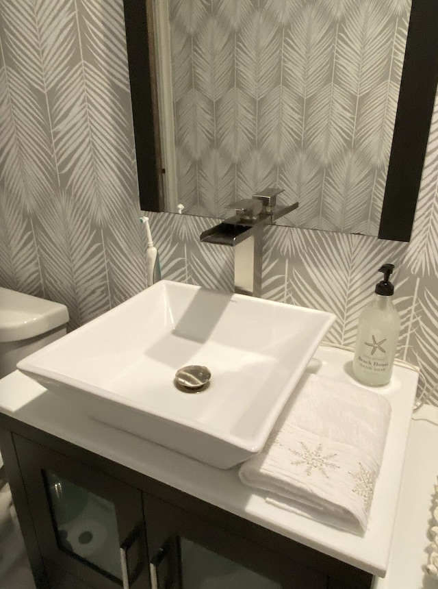 9124 Sun Terrace Cir Unit D, West Palm Beach, FL 33403 - bathroom featuring wallpapered walls, vanity, and toilet