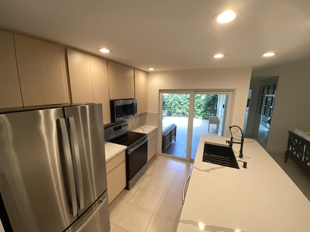9124 Sun Terrace Cir Unit D, West Palm Beach, FL 33403 - kitchen with appliances with stainless steel finishes, light countertops, a sink, recessed lighting, and light tile patterned floors