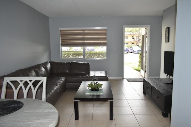 251 NW 76th Ave Unit 105, Margate, FL 33063 - living area with healthy amount of natural light, light tile patterned floors, and baseboards