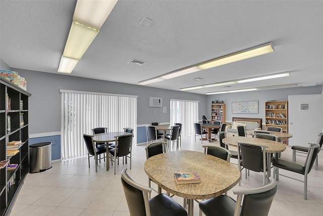 251 NW 76th Ave Unit 105, Margate, FL 33063 - dining room with a textured ceiling and light tile patterned floors