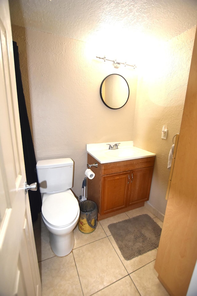 251 NW 76th Ave Unit 105, Margate, FL 33063 - bathroom featuring vanity, toilet, a textured wall, and tile patterned floors