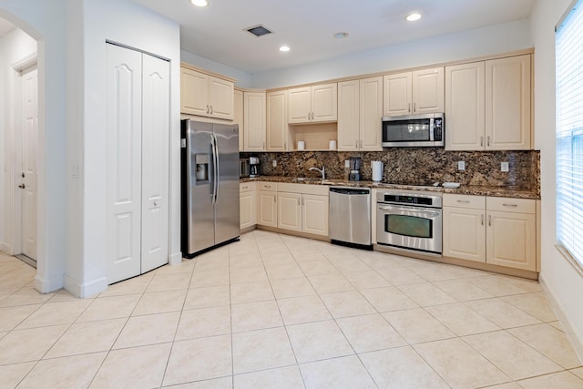 2812 Eagle Rock Cir Unit 902, West Palm Beach, FL 33411 - kitchen with appliances with stainless steel finishes, decorative backsplash, arched walkways, dark stone countertops, and recessed lighting