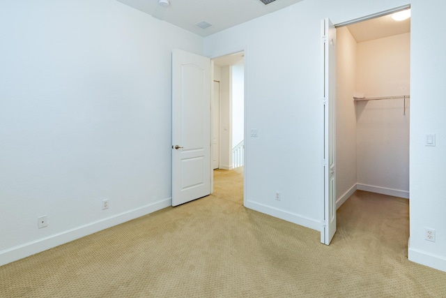 2812 Eagle Rock Cir Unit 902, West Palm Beach, FL 33411 - unfurnished bedroom featuring light carpet, a walk in closet, and a closet