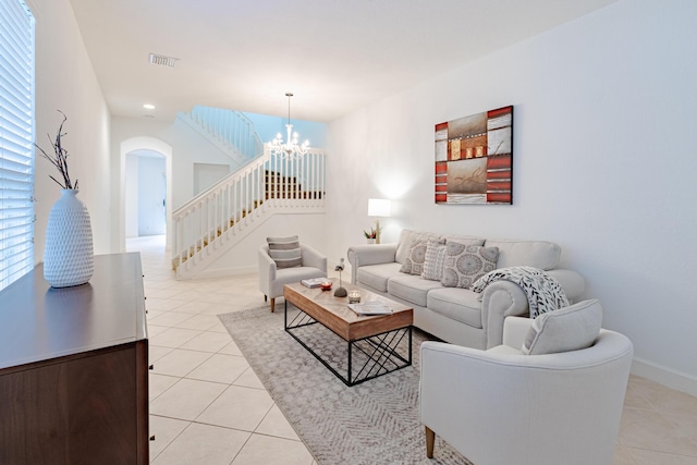 2812 Eagle Rock Cir Unit 902, West Palm Beach, FL 33411 - living room with a chandelier, light tile patterned floors, arched walkways, and stairway