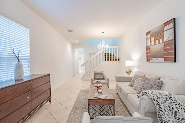 2812 Eagle Rock Cir Unit 902, West Palm Beach, FL 33411 - living area featuring a chandelier, arched walkways, stairway, light tile patterned floors, and plenty of natural light