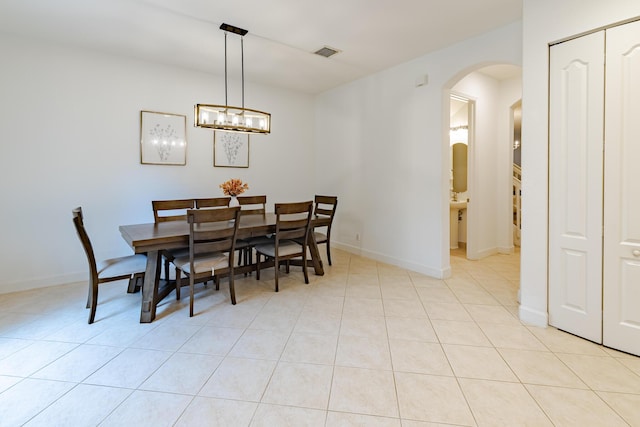 2812 Eagle Rock Cir Unit 902, West Palm Beach, FL 33411 - dining room with arched walkways, light tile patterned floors, and a chandelier
