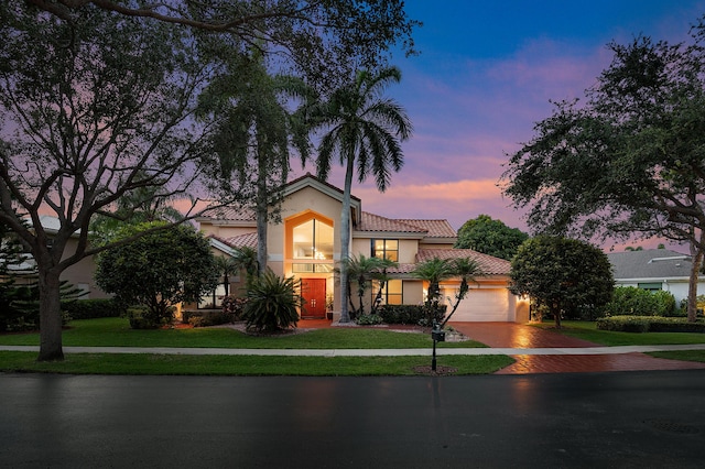 3049 NW 61st St, Boca Raton, FL 33496 - mediterranean / spanish house featuring a tile roof, stucco siding, driveway, a garage, and a yard