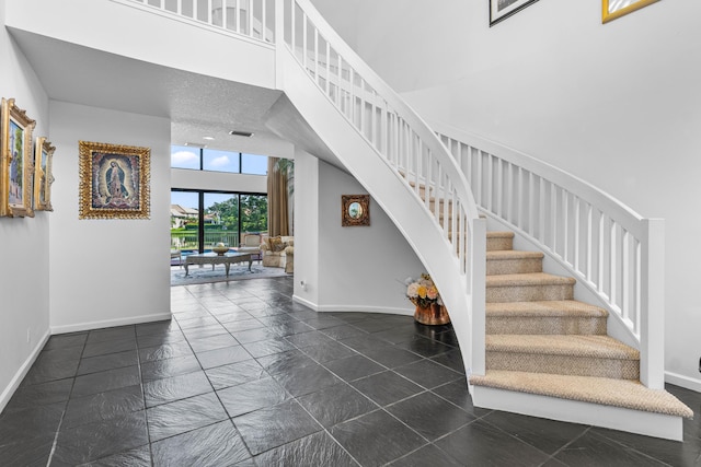 3049 NW 61st St, Boca Raton, FL 33496 - stairs featuring baseboards and a high ceiling