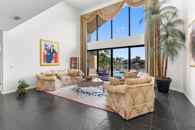 3049 NW 61st St, Boca Raton, FL 33496 - living area with a towering ceiling, baseboards, and a water view