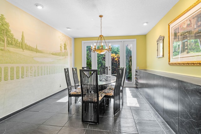 3049 NW 61st St, Boca Raton, FL 33496 - dining room with a chandelier, a textured ceiling, and french doors