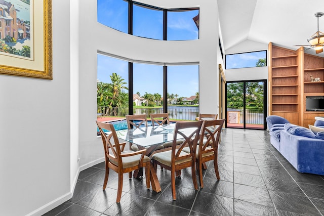 3049 NW 61st St, Boca Raton, FL 33496 - dining room featuring built in features, lofted ceiling, and baseboards