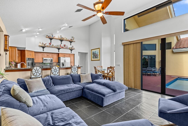 3049 NW 61st St, Boca Raton, FL 33496 - living area with a ceiling fan, dark tile patterned floors, high vaulted ceiling, and a textured ceiling