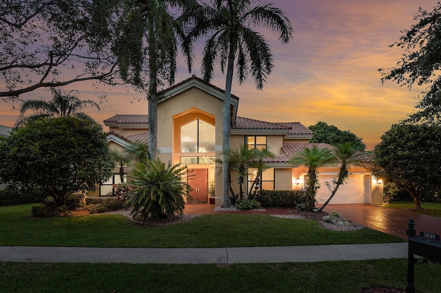 3049 NW 61st St, Boca Raton, FL 33496 - view of front of property featuring stucco siding, a tiled roof, a front lawn, and a garage