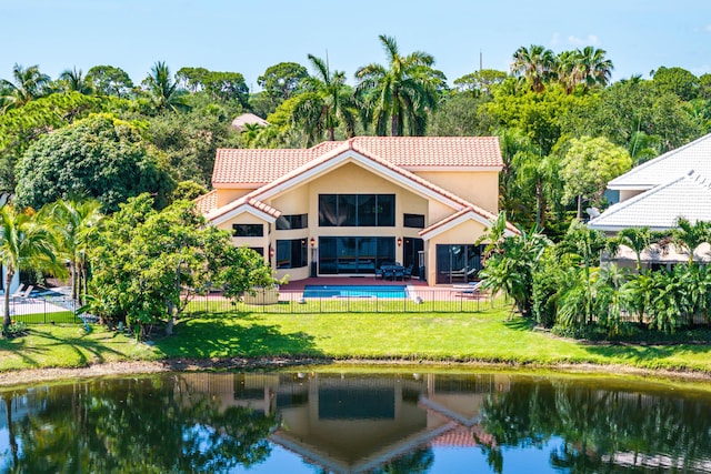3049 NW 61st St, Boca Raton, FL 33496 - rear view of property featuring stucco siding, a tiled roof, and a water view