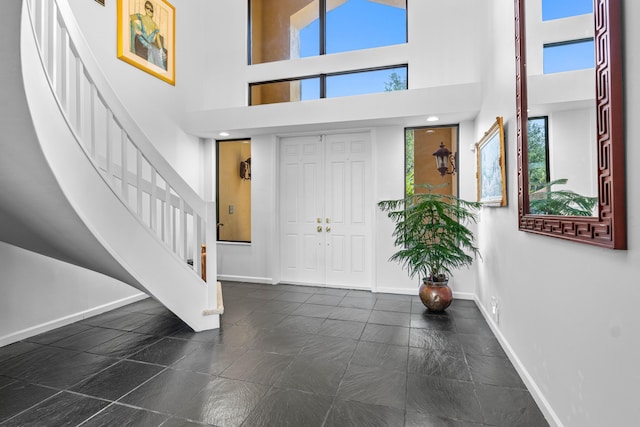 3049 NW 61st St, Boca Raton, FL 33496 - entrance foyer featuring stairway, baseboards, plenty of natural light, and a high ceiling