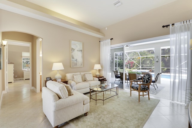 10120 Inverness Way, Port Saint Lucie, FL 34986 - living room with light tile patterned flooring, arched walkways, a sunroom, and plenty of natural light