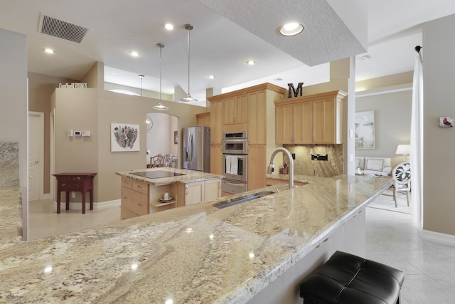 10120 Inverness Way, Port Saint Lucie, FL 34986 - kitchen featuring stainless steel appliances, a sink, light brown cabinets, light tile patterned floors, and baseboards